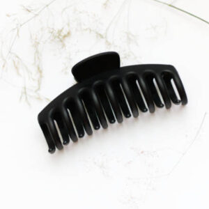 Black plastic claw clip hair accessory laid on a white background.